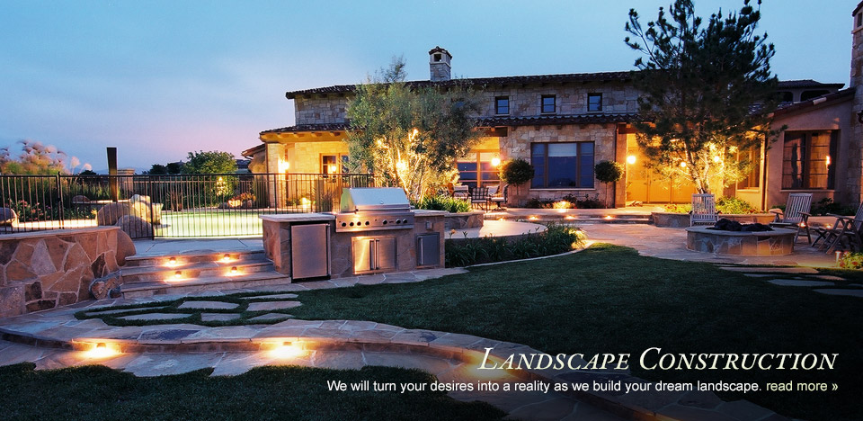 Landscape Construction — illuminated residential backyard at twilight